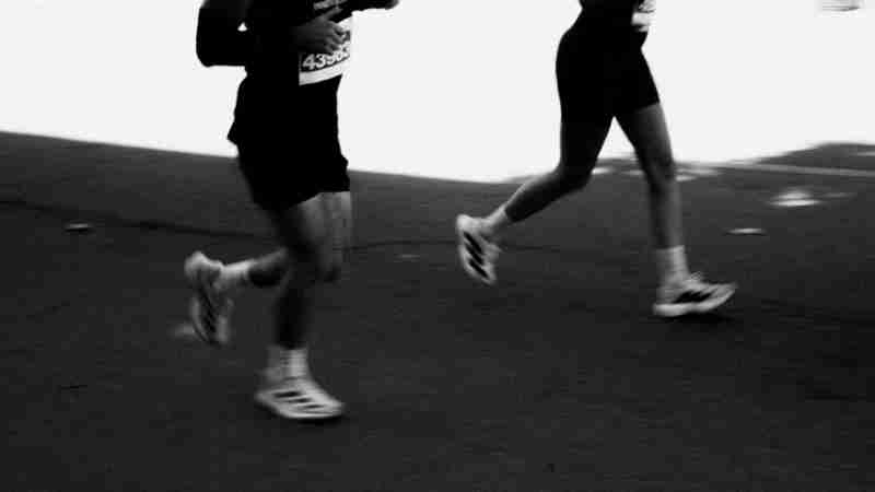 Dynamic black and white shot of marathon runners captured mid-stride, emphasizing movement and athleticism., tags: und - pexel